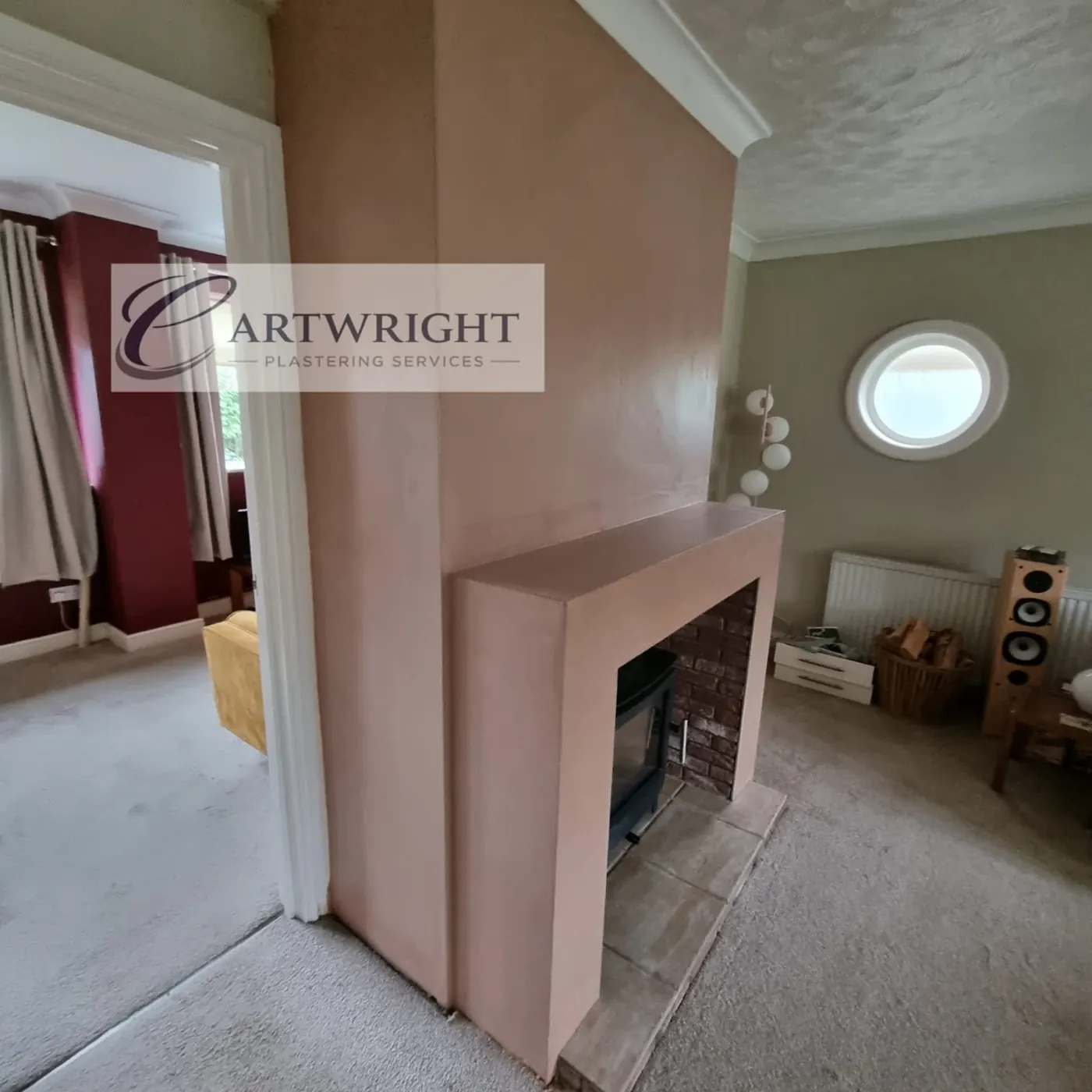 Plastered chimney breast with hearth and stove