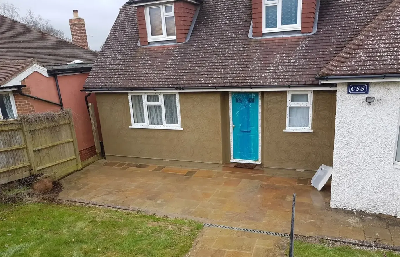 Sand and cement render applied to the front of a house