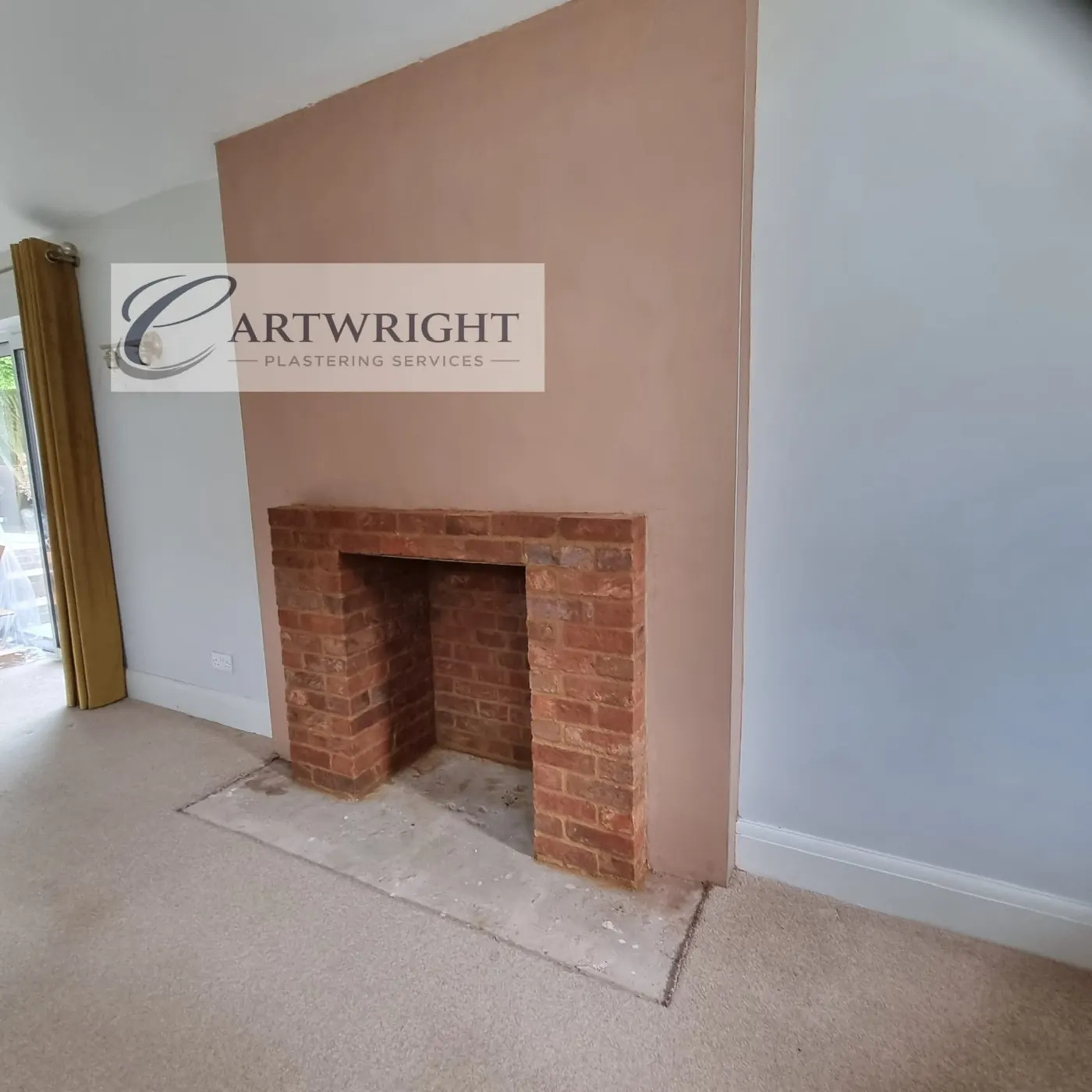 Re-plastered chimney breast around a brick fireplace
